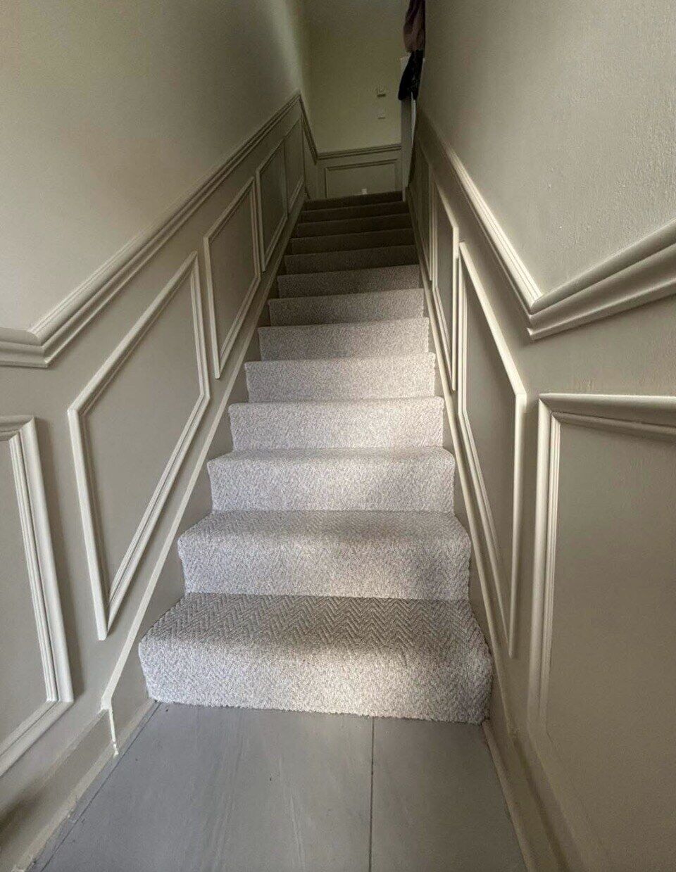 Panelled staircase finished by Romenzo Construction