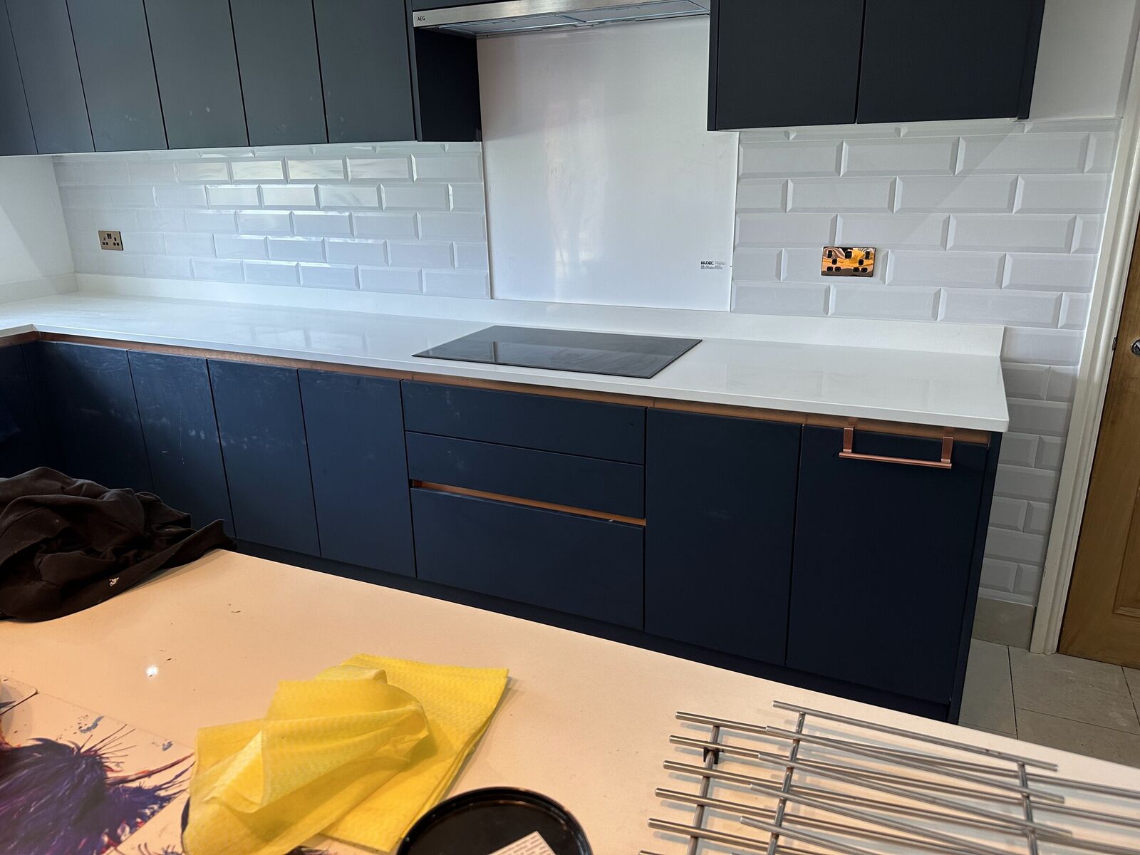 Navy kitchen with white metro tiles and quartz worktops
